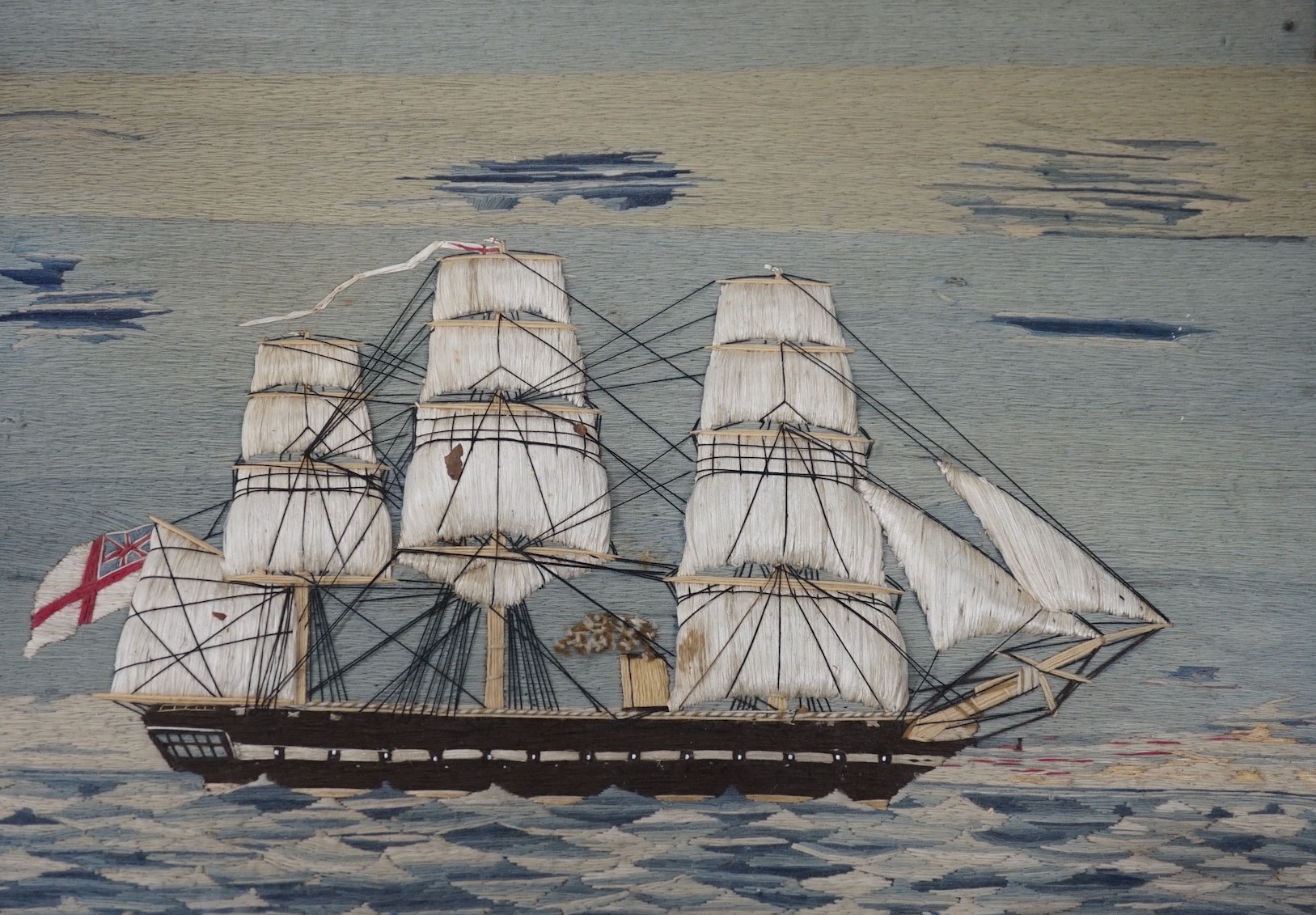 A maple framed 19th century wool work embroidery of a steam ship of the English fleet, 63cms wide, 47cms high